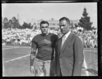 UCLA football coach Bill Spaulding and team captain Joe Fleming on UCLA playing field, Los Angeles, circa 1928