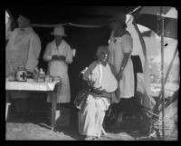 Three relief workers and a treated woman in a tent at a disaster relief station after the earthquake, Santa Barbara, 1925