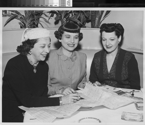 Photograph of Barbara Rosien with two women examining a map of Los Angeles
