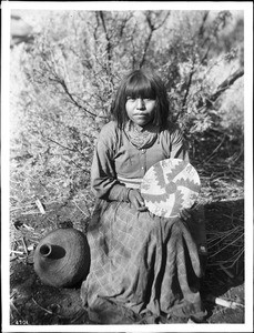 The Havasupai Indian Waluthama's daughter showing basket she made, ca.1900
