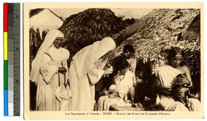 Missionaies caring for women and young children, India, ca.1920-1940
