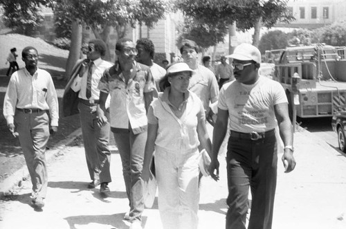 Kim Fields walking with Rev. Bill Minson near L.A. City Hall, Los Angeles, 1983