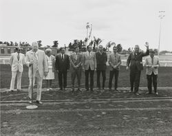 Members of the board and others standing on the race track at the Sonoma County Fairgrounds, 1972