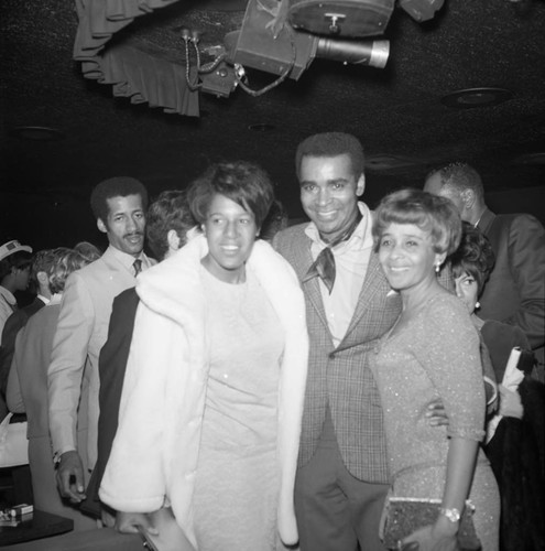 Greg Morris posing with Lorraine and Ethel Bradley at a Tom Bradley mayoral campaign event, Los Angeles, 1969