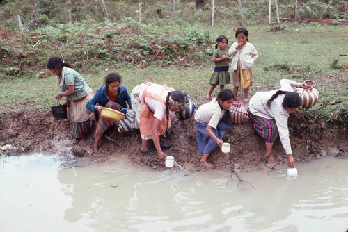 Guatemalan refugees collecting water at a River, Santiago el Vértice, 1983