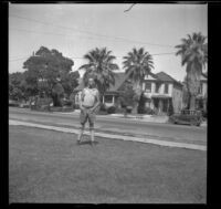 H. H. West stands on the front lawn of the West's house at 2223 Griffin Avenue, Los Angeles, about 1930