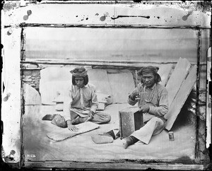 Two Zuni Indian men making wampum, ca.1900