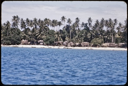 Kaileuna Island: Kaduaga village houses, canoes and beach