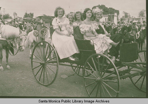 Women in costume riding in a carriage in the Pacific Palisades Fiesta Day Parade