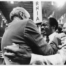 Senator Alan Cranston embraces Willie Brown after Brown's speech at the Democratic National Convention