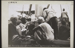 Hausa traders at their meal on board the Alex. Woermann