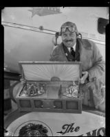 Col. Roscoe Turner holds gold sea chest intended for President Hoover, Los Angeles, 1932