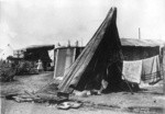 [Makeshift refugee shelters. Unidentified location]