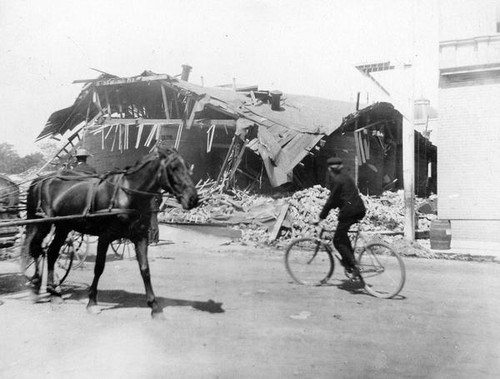 Passersby look on at the 1906 earthquake devastation