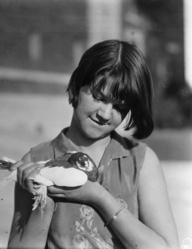 Woman cradling a pigeon