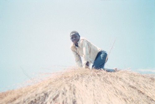 Man thatching roof at Kaputa