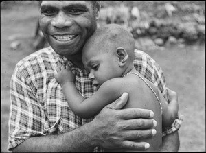 A New Caledonian missionary carrying in his arms the son of a leader of the New Hebrides