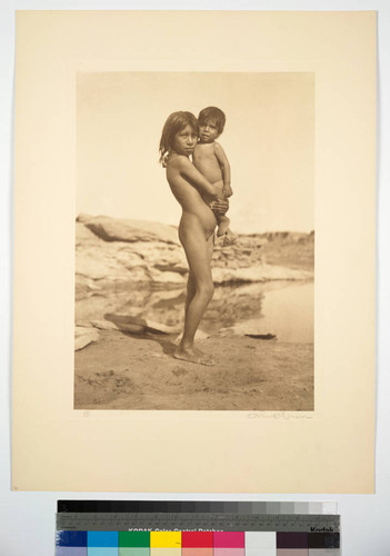 Mojave girl holding a young boy in her arms