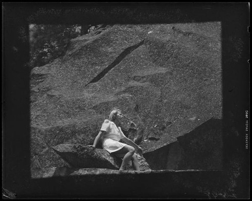 Carolyn Bartlett seated on rock, Yosemite National Park, 1941