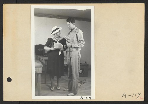 Poston, Ariz.--Mrs. Lyle Kurisaki, evacuee of Japanese ancestry, and Norris James, WRA official, in an interview at this War Relocation Authority center during a CBS nationwide hookup. Photographer: Clark, Fred Poston, Arizona