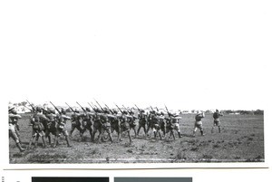 Soldiers walking across a field, Africa