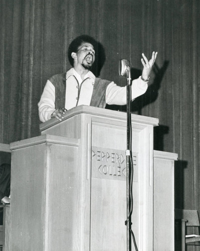 Student singing in auditorium, circa 1970