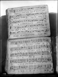 Two pages in a damaged Mission music book at Mission Santa Barbara, ca.1900