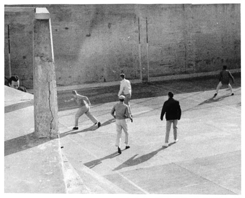 [Prisoners playing handball in Alcatraz Prison recreation yard]