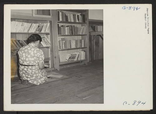 Manzanar, Calif.--A corner in the library at this War Relocation Authority center for evacuees of Japanese ancestry. This section contains books in the Japanese language most of which are translations of English classics. Photographer: Lange, Dorothea Manzanar, California