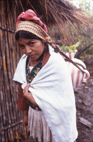 A Mayan woman carries a jug on her back, Chajul, ca. 1983