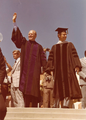 President Ford with William Banowsky waving to crowd following Firestone Fieldhouse dedication, 1975