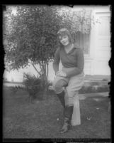 Aviatrix Peggy Paxson sitting in her aviator's outfit, Calif., circa 1929
