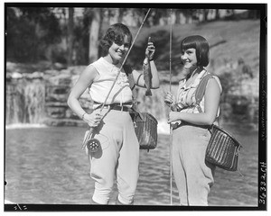 Jewell Teegardin and Beatrice Williams holding up a rainbow trout, at Rainbow Angling Club, Azusa, October 1930