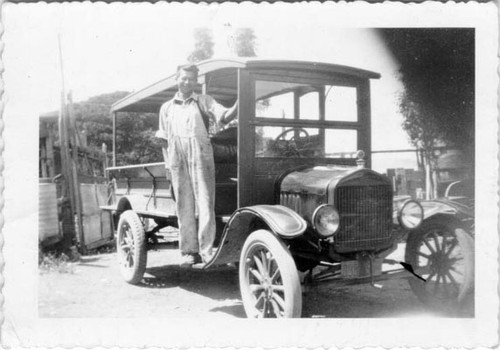 [Unidentified man posing with an automobile in Visitacion Valley]