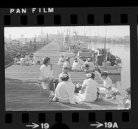 Women cannery workers taking lunch break on dock on Terminal Island, Calif., 1975