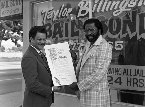 Taylor Billingslea posing with Bob Farrell in front of Billingslea Bail Bonds, Los Angeles, 1983