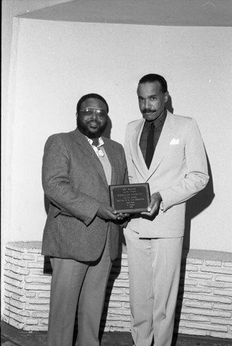 Phillip Fenty posing with an award at the Pied Piper nightclub, Los Angeles, 1986