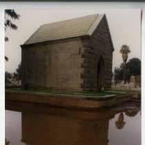 Exterior view of the Sacramento City Cemetery Mortuary Chapel and Archives Office on the grounds of the cemetery. This view shows water in the parking lot after a rain storm