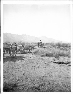Pima Indian farmers in wagons or on horses enroute to an irrigation dam construction site, ca.1900