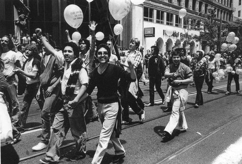 Parade participants carrying balloons