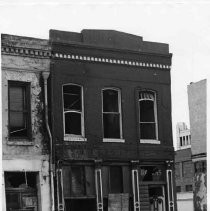 Photograph of Rivett Building in Old Sacramento, prior to restoration, K Street side
