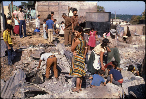 Civilians search through the rubble, La Palma, Chalatenango, 1983