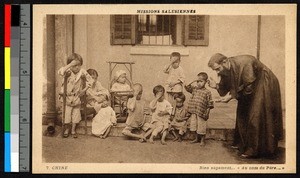 Priest showing children how to pray, China, ca.1920-1940