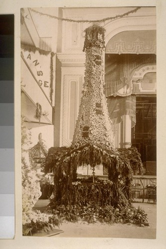 [Flower-covered tower-like structure : booth for an agricultural exhibition?]