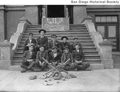 Baseball team players from Logan Heights School posing on the school steps