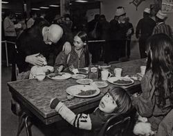 Fr. Boeddeker and child at the St. Anthony's Dining Room, 121 Golden Gate Avenue, San Francisco, California, February 1979