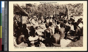 Missionary father catechizes in a village, Congo, ca.1900-1930
