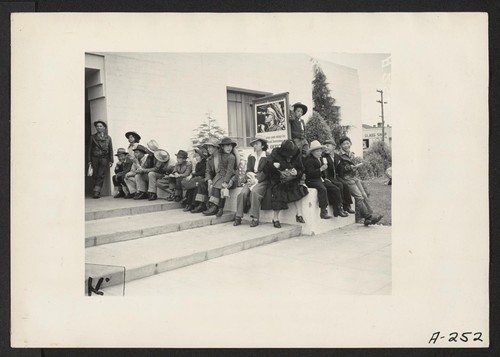 Salinas, Calif.--Evacuees of Japanese ancestry wait for the bus which will take them to the Santa Anita Assembly Center. They will later be transferred to a War Relocation Authority center to spend the duration. Photographer: Albers, Clem Salinas, California
