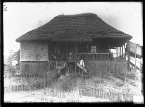 Swiss missionaries on the porch of a building, Mozambique