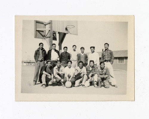 Group of young men and a woman on a basketball court